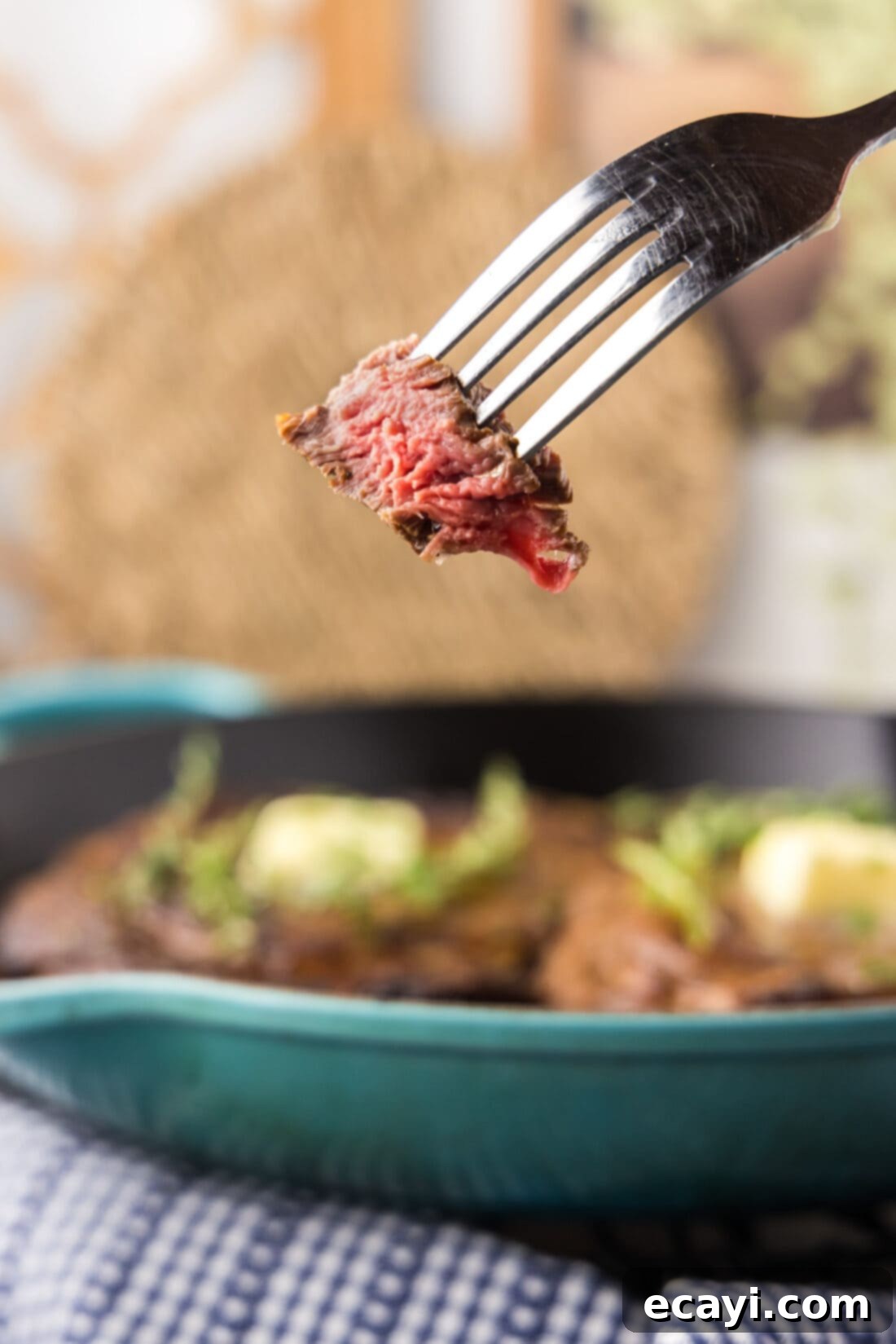 The Ultimate Cast Iron Ribeye 10 A delicious piece of Cast Iron Ribeye on a fork, showing its juicy interior and perfect crust