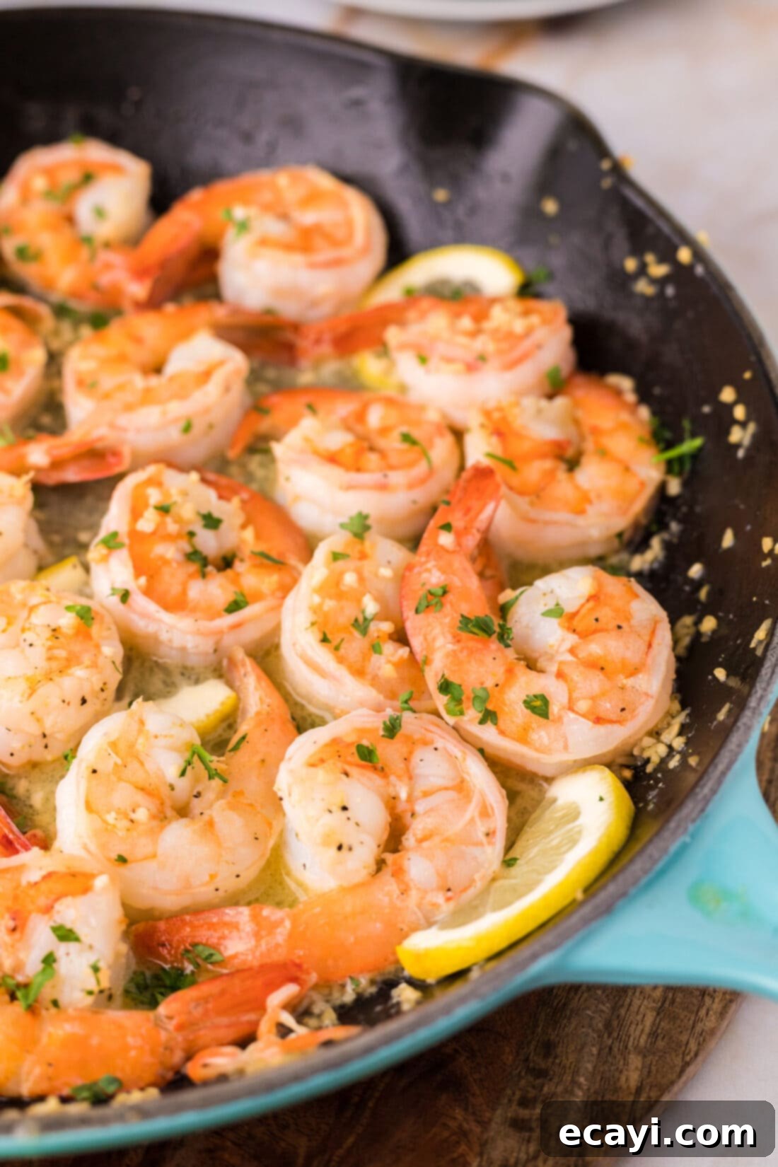 Sizzling Garlic Butter Shrimp 2 Close up of perfectly cooked Garlic Butter Shrimp in a skillet, showcasing golden-pink shrimp glistening in sauce
