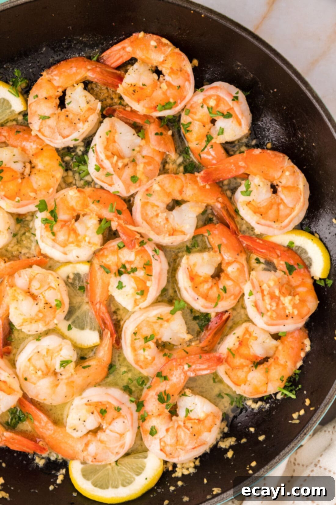 Sizzling Garlic Butter Shrimp 14 Overhead shot of freshly cooked Garlic Butter Shrimp in a skillet, glistening with lemon garlic butter sauce and ready to be served