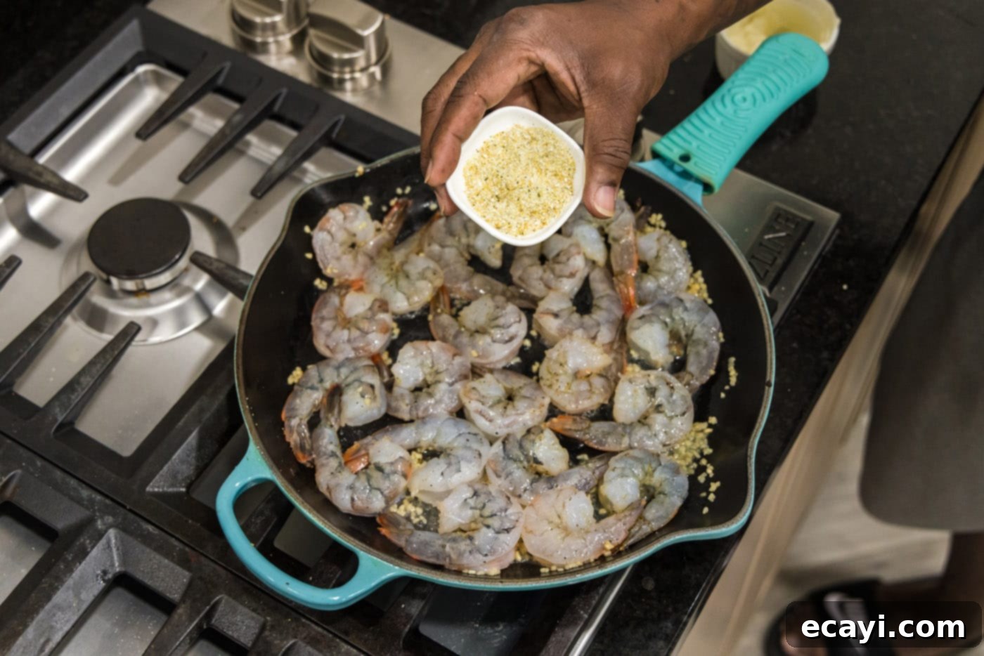 Sizzling Garlic Butter Shrimp 9 Sprinkling additional seasoning onto shrimp in a skillet