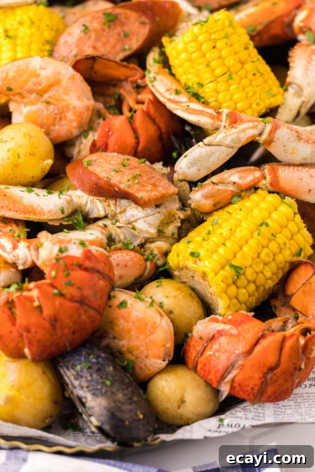 Ocean's Harvest Party 12 Close up image of Seafood Boil with crab legs, corn, and lobster