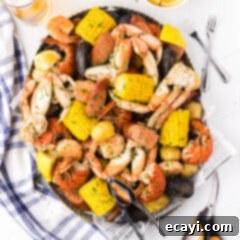 Ocean's Harvest Party 13 Seafood Boil in a metal serving platter with seafood utensils on the side