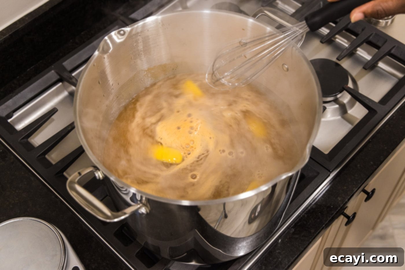 Ocean's Harvest Party 5 stirring lemon wedges, old bay, and garlic salt in a pot of water