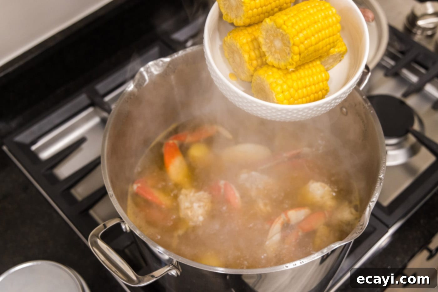 Ocean's Harvest Party 8 adding corn to pot of water with crab legs
