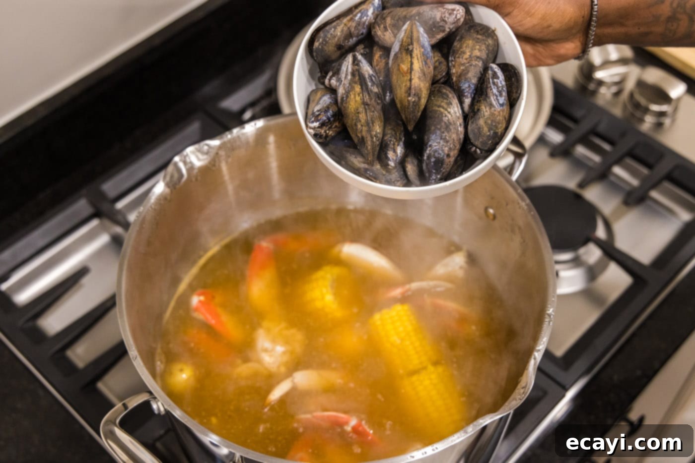 Ocean's Harvest Party 9 adding mussels to pot with seafood boil