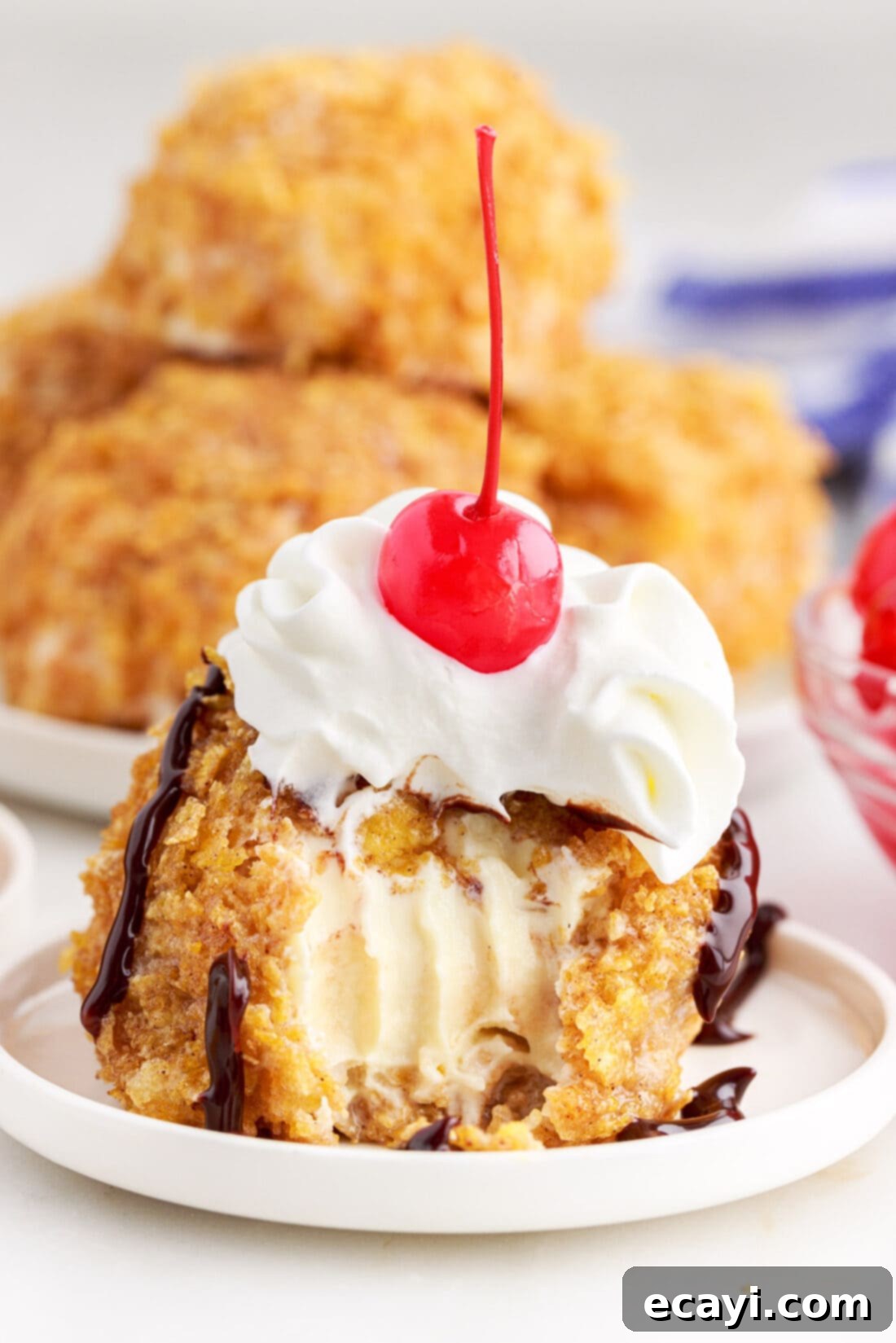 Crispy-Coated Cream Dream 2 Fried Ice Cream on a plate with a bite taken out