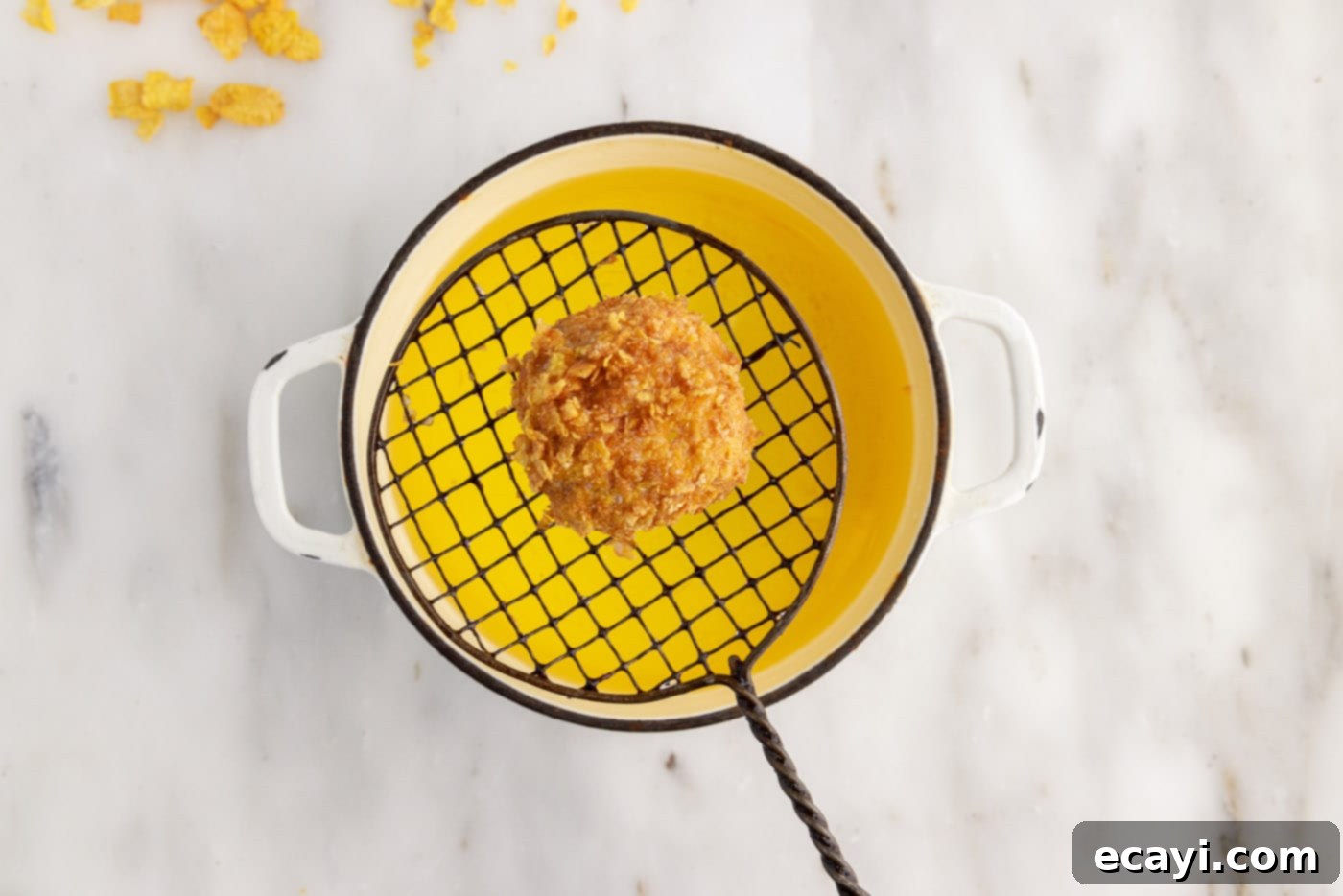 Crispy-Coated Cream Dream 15 lifting fried ice cream ball from oil