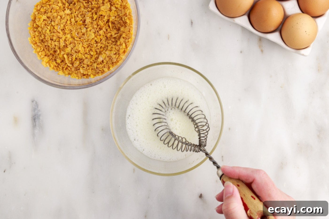 Crispy-Coated Cream Dream 7 frothing egg whites in a bowl