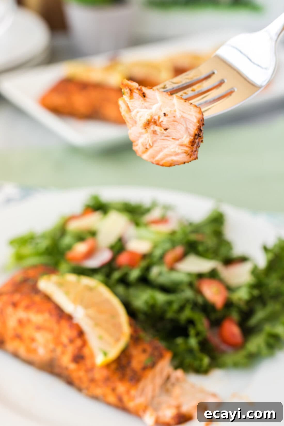 Easy Crispy Air Fryer Salmon 3 Close up of a piece of Air Fryer Salmon on a fork, showing its flaky texture
