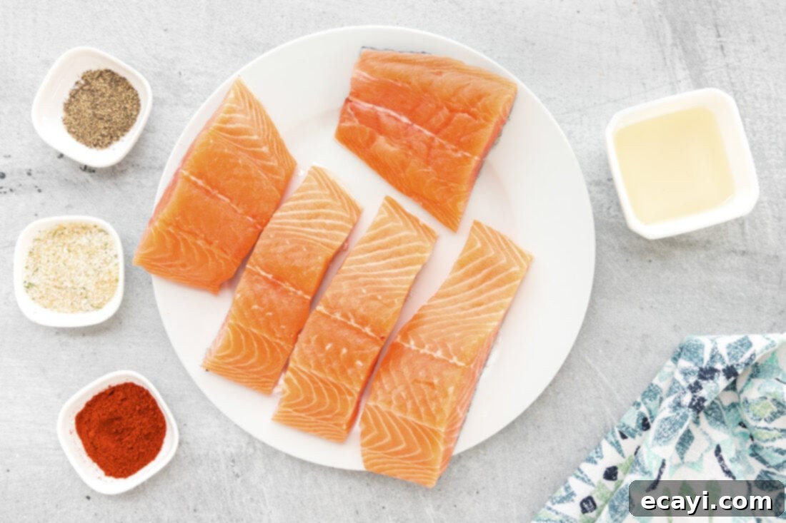 Easy Crispy Air Fryer Salmon 4 Collection of ingredients for Air Fryer Salmon including salmon filets, olive oil, garlic salt, paprika, and pepper