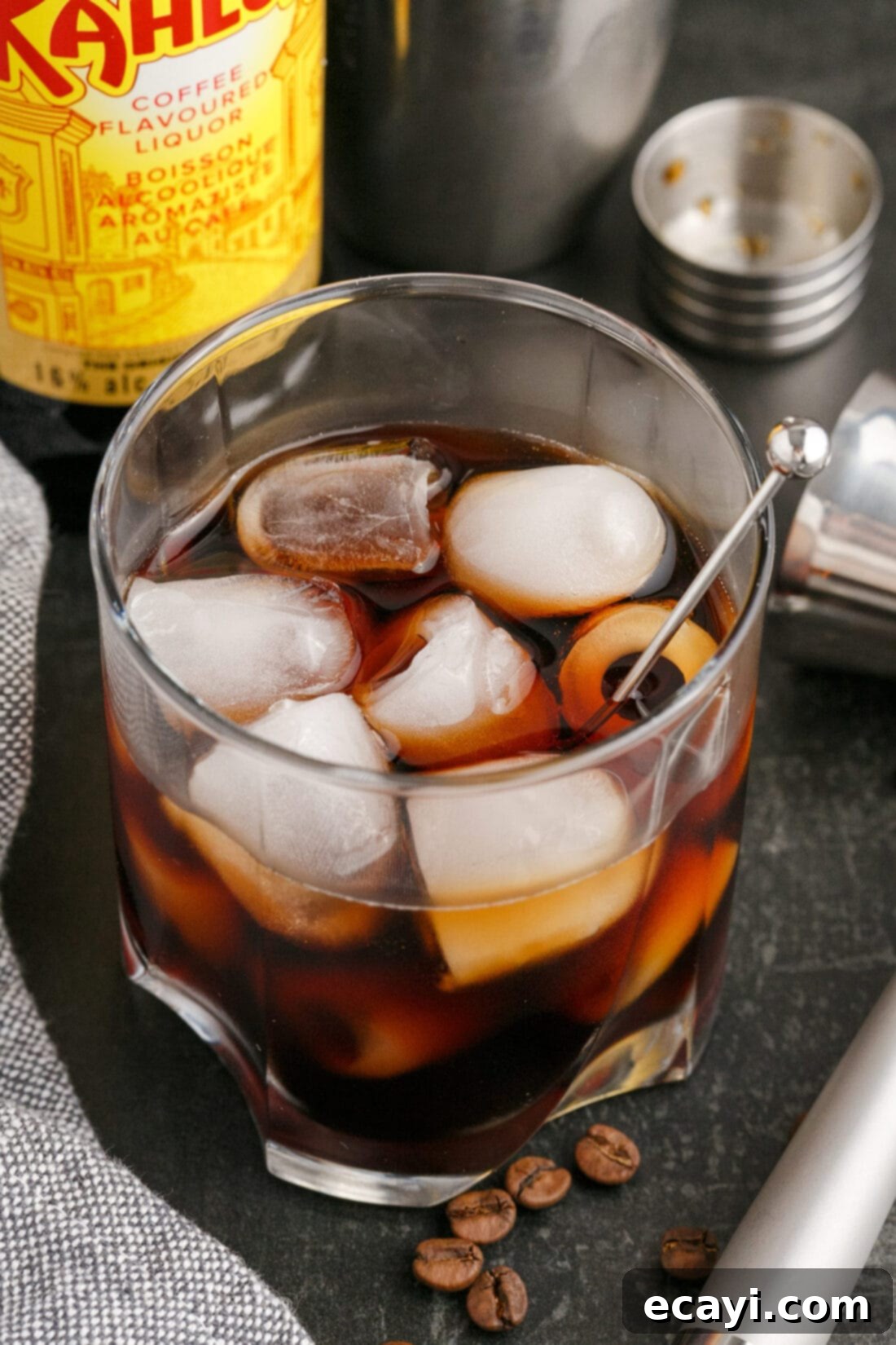 Siberian Night 2 Black Russian with a Kahlua bottle in the background, highlighting its key ingredient