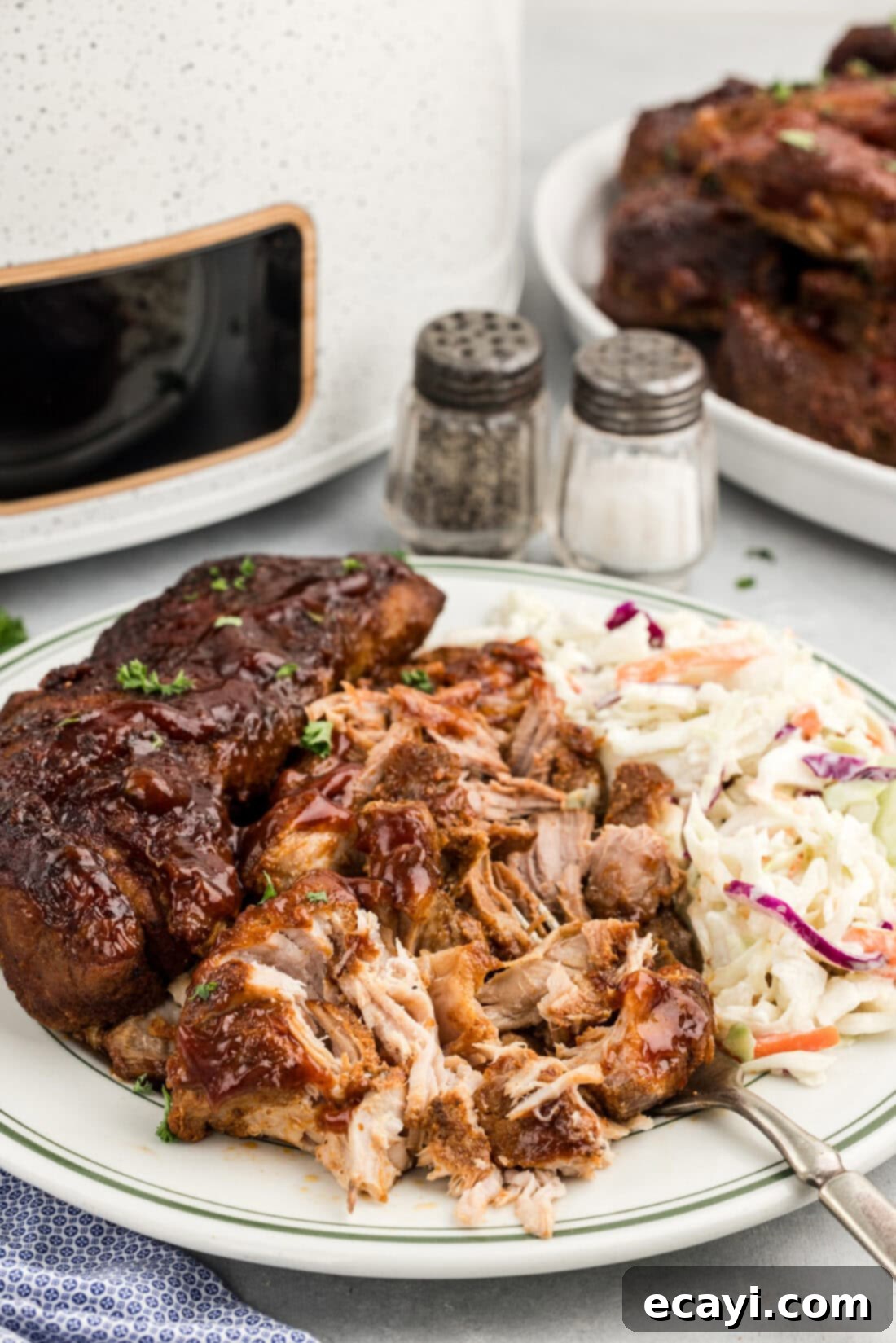 Fall-Off-The-Bone Slow Cooker BBQ Country Ribs 11 Shredded Slow Cooker Barbecued Country Style Ribs on a plate