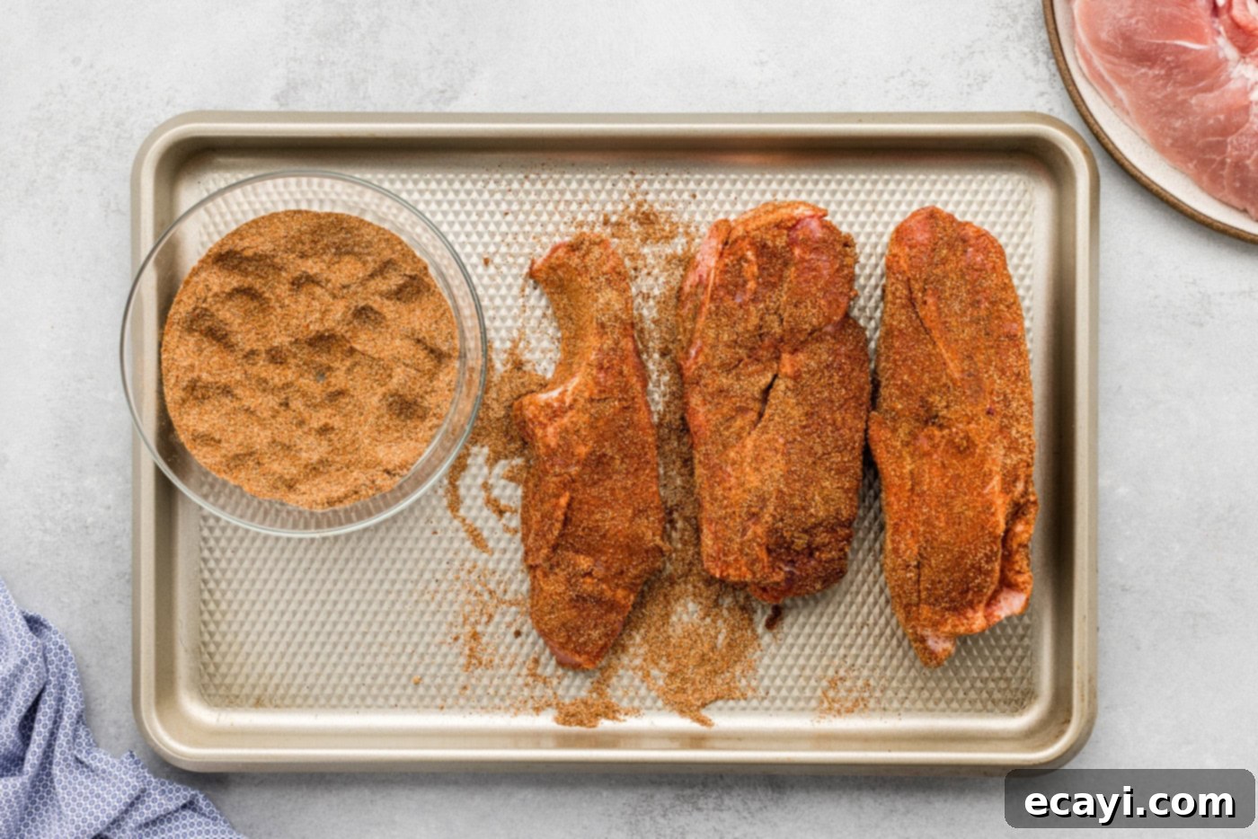 Fall-Off-The-Bone Slow Cooker BBQ Country Ribs 7 country style ribs rubbed with seasonings on a baking sheet