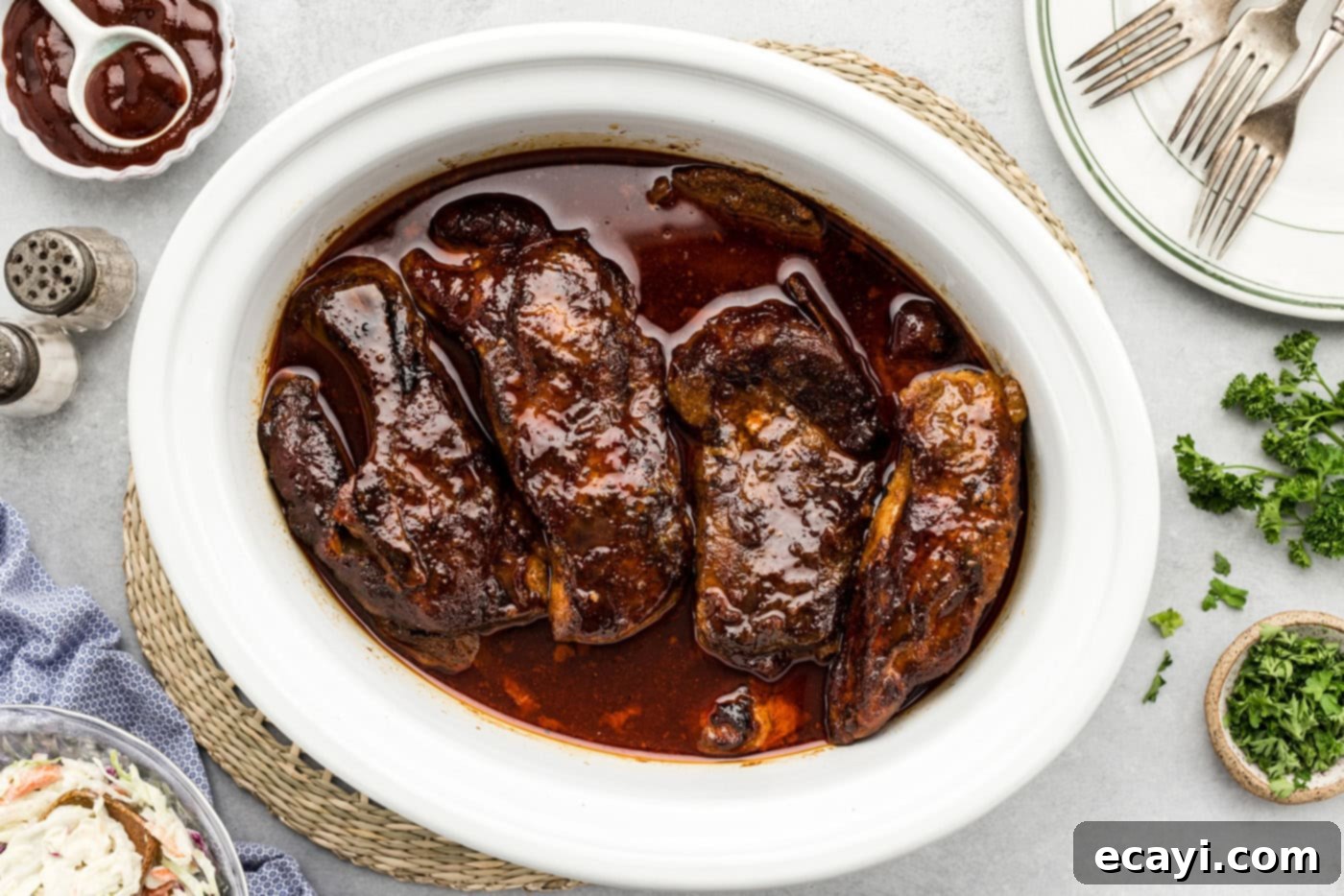 Fall-Off-The-Bone Slow Cooker BBQ Country Ribs 10 slow cooker country style ribs with barbecue sauce in a crock