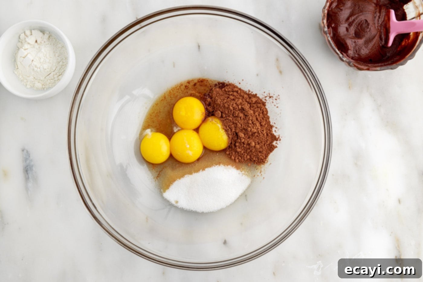Molten Chocolate Bliss 9 eggs, cocoa powder, vanilla, and sugar in a bowl