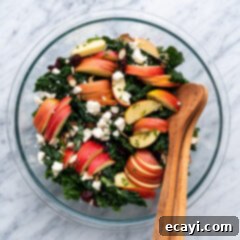 Signature Kale Salad 13 Bowl of Kale Salad with serving spoons in the bowl