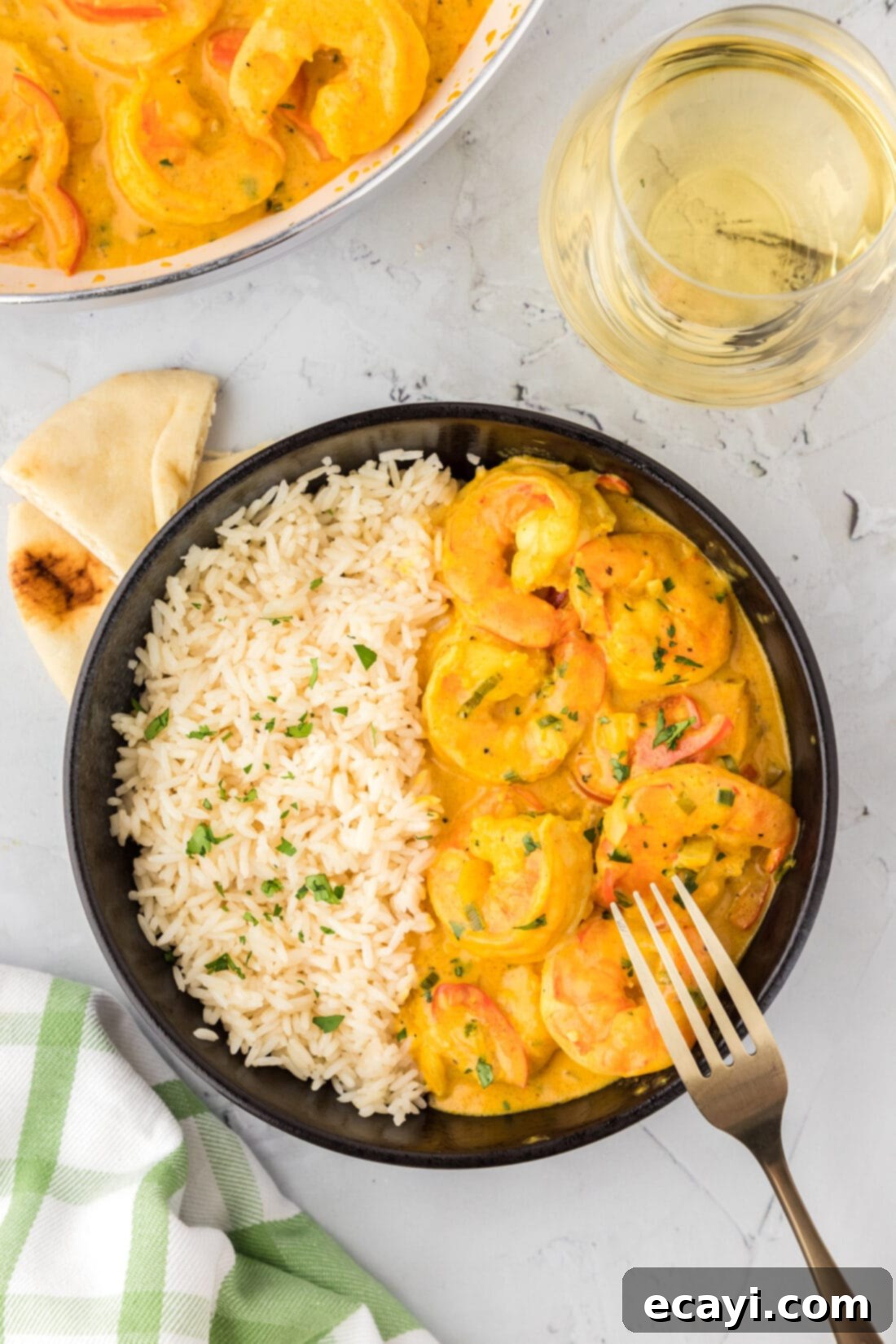 Mouthwatering Shrimp Curry 12 A beautifully presented bowl of creamy shrimp curry, garnished with fresh green onions and served alongside fluffy white rice, ready to be enjoyed.