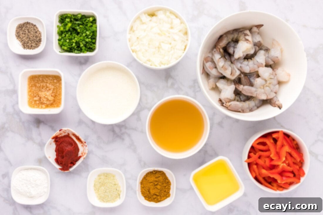 Mouthwatering Shrimp Curry 4 A flat lay photograph showcasing all the fresh ingredients for Shrimp Curry, including raw shrimp, chopped onions, red bell peppers, green onions, and various spices arranged neatly on a surface.