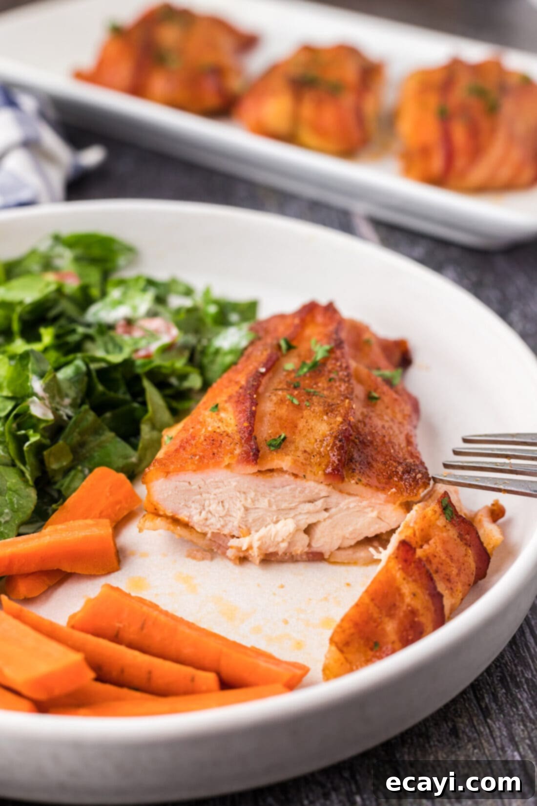 Crispy Bacon-Wrapped Chicken 3 Bacon Wrapped Chicken on a plate cut open