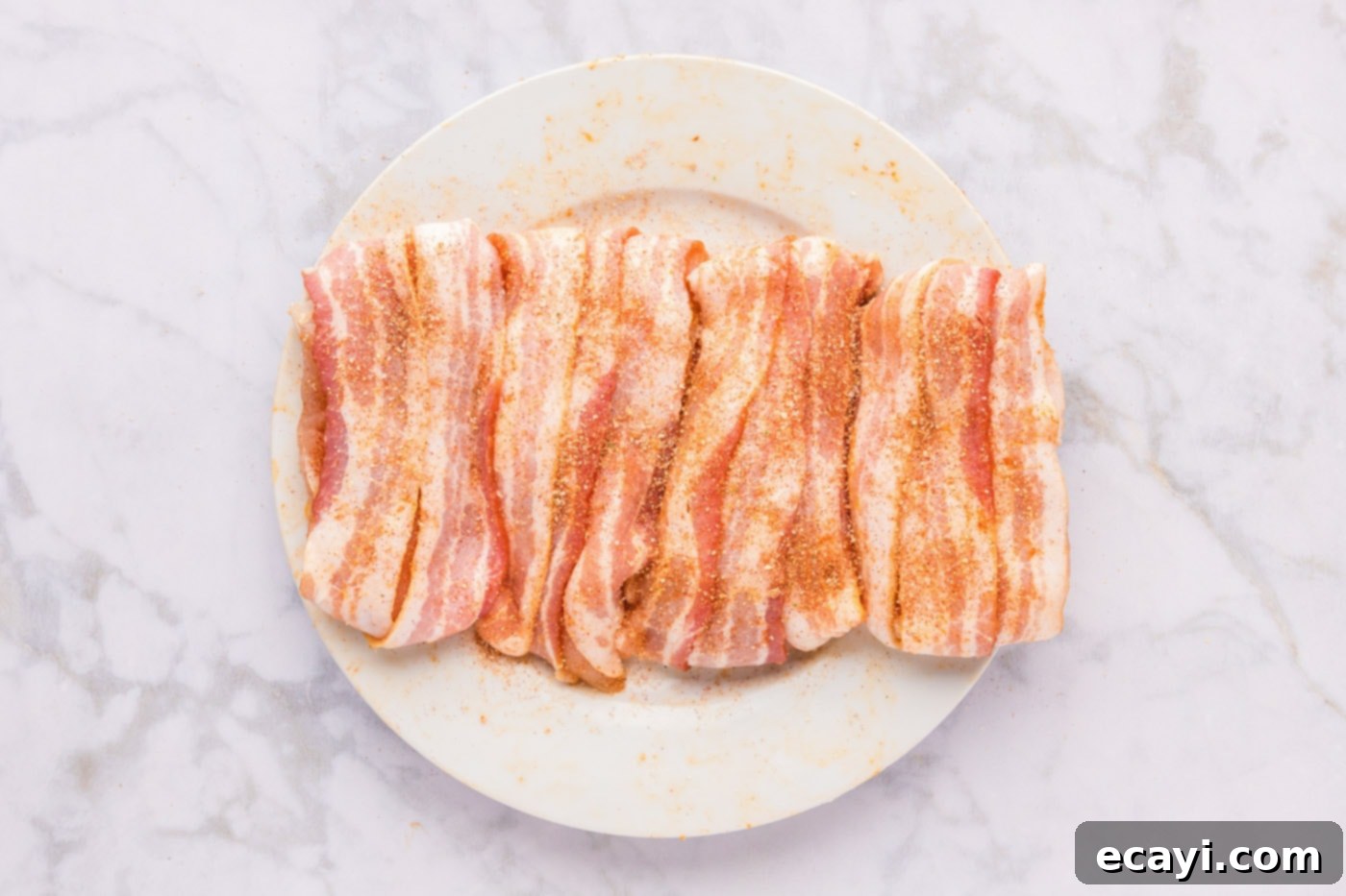 Crispy Bacon-Wrapped Chicken 8 bacon wrapped chicken breasts on a plate
