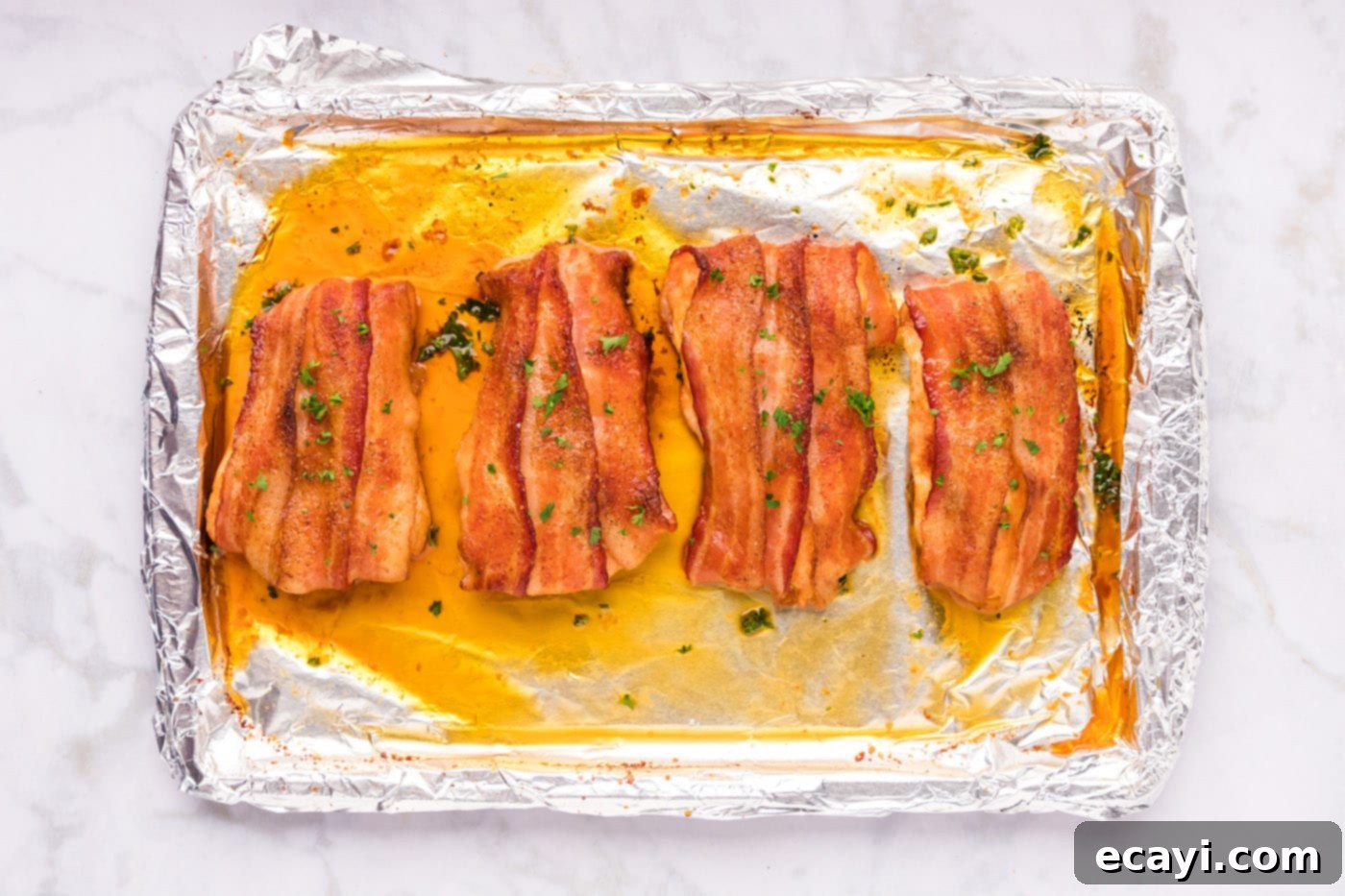 Crispy Bacon-Wrapped Chicken 10 finished bacon wrapped chicken on a baking sheet