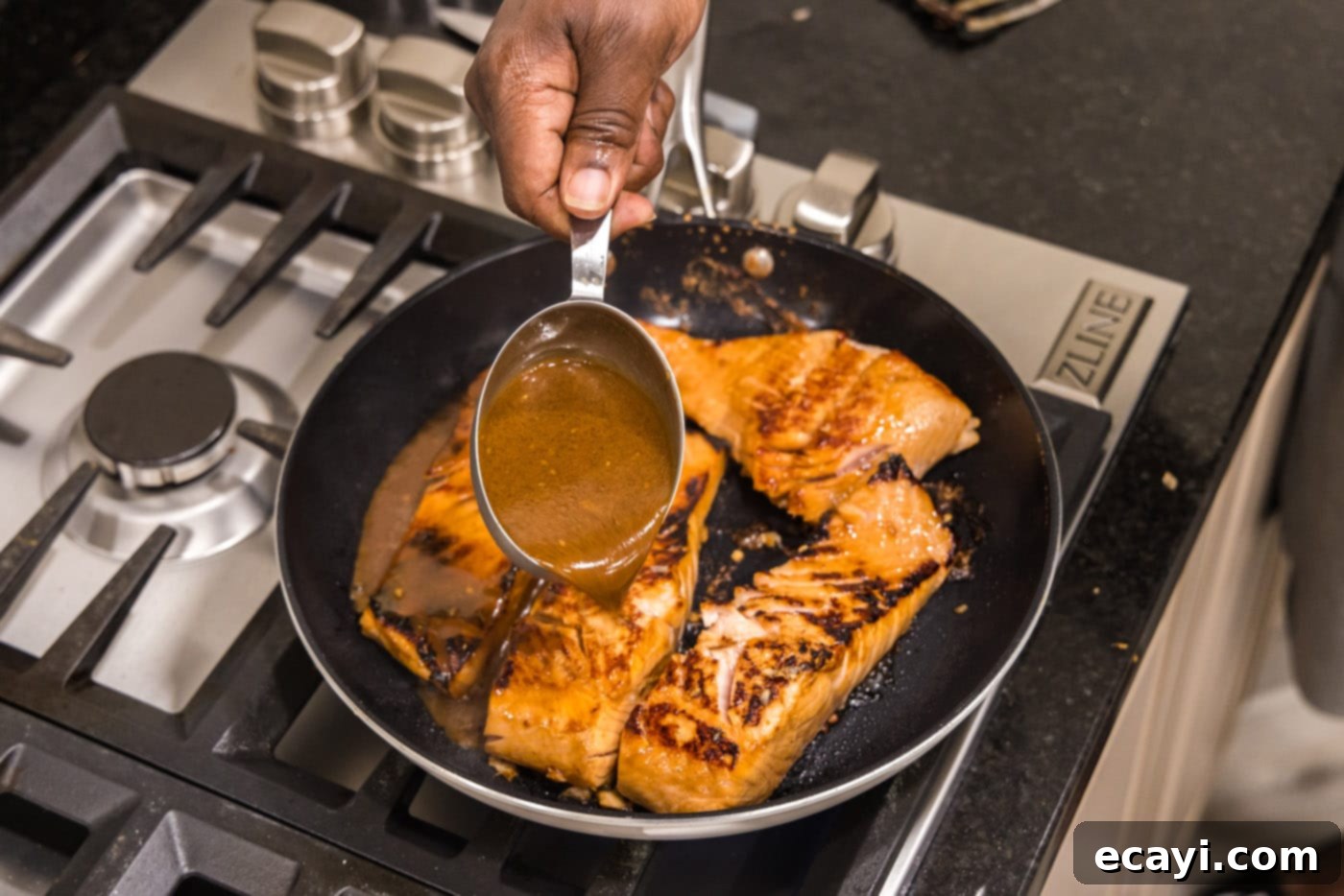 Sweet & Savory Teriyaki Salmon 8 pouring teriyaki sauce into pan with salmon