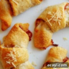 Cheesy Pizza Crescents 8 A close up photo of pizza crescent roll ups.