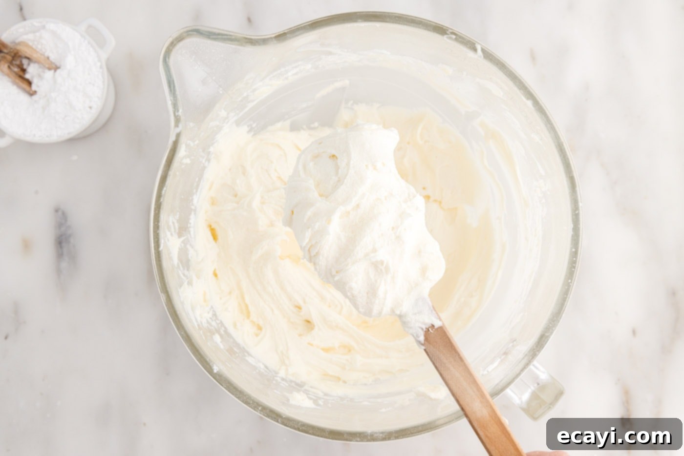 Pineapple Coconut Paradise 20 cream cheese frosting on a spatula, showing smooth and creamy texture