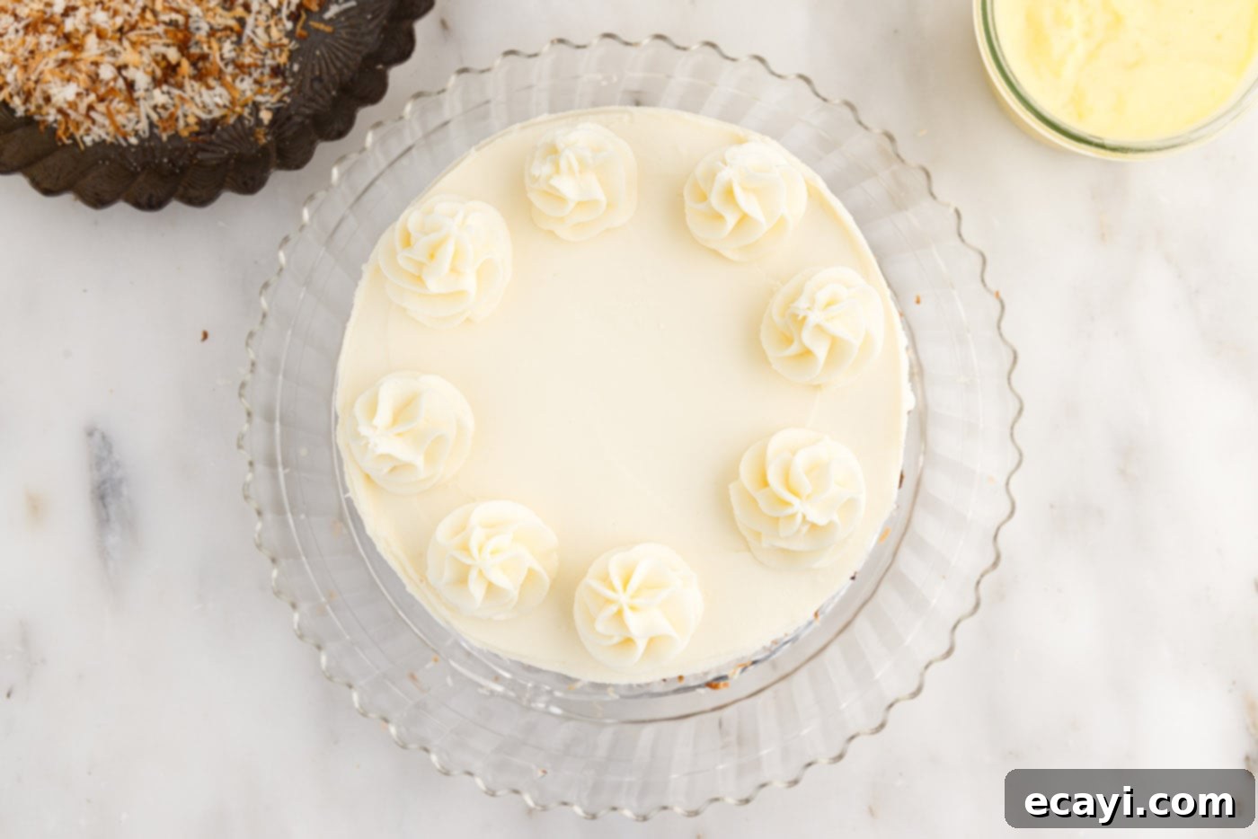 Pineapple Coconut Paradise 23 piped cream cheese frosting decorations on top of the frosted cake