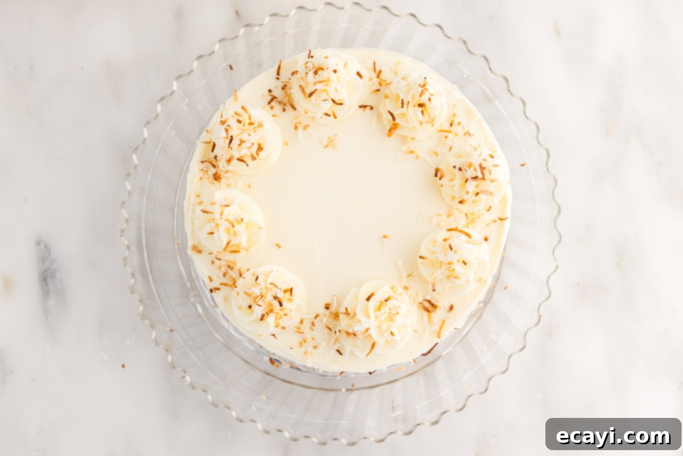 Pineapple Coconut Paradise 24 toasted coconut added on top of frosted pineapple coconut cake for garnish