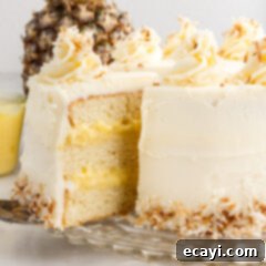 Pineapple Coconut Paradise 26 Pineapple Coconut Cake on a cake stand with a slice being removed