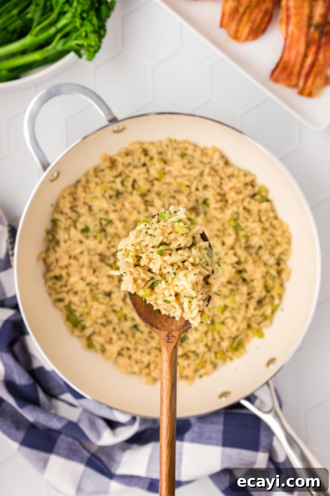 Savory Pilaf Perfection 3 Spoonful of Rice Pilaf held above a skillet of Rice Pilaf
