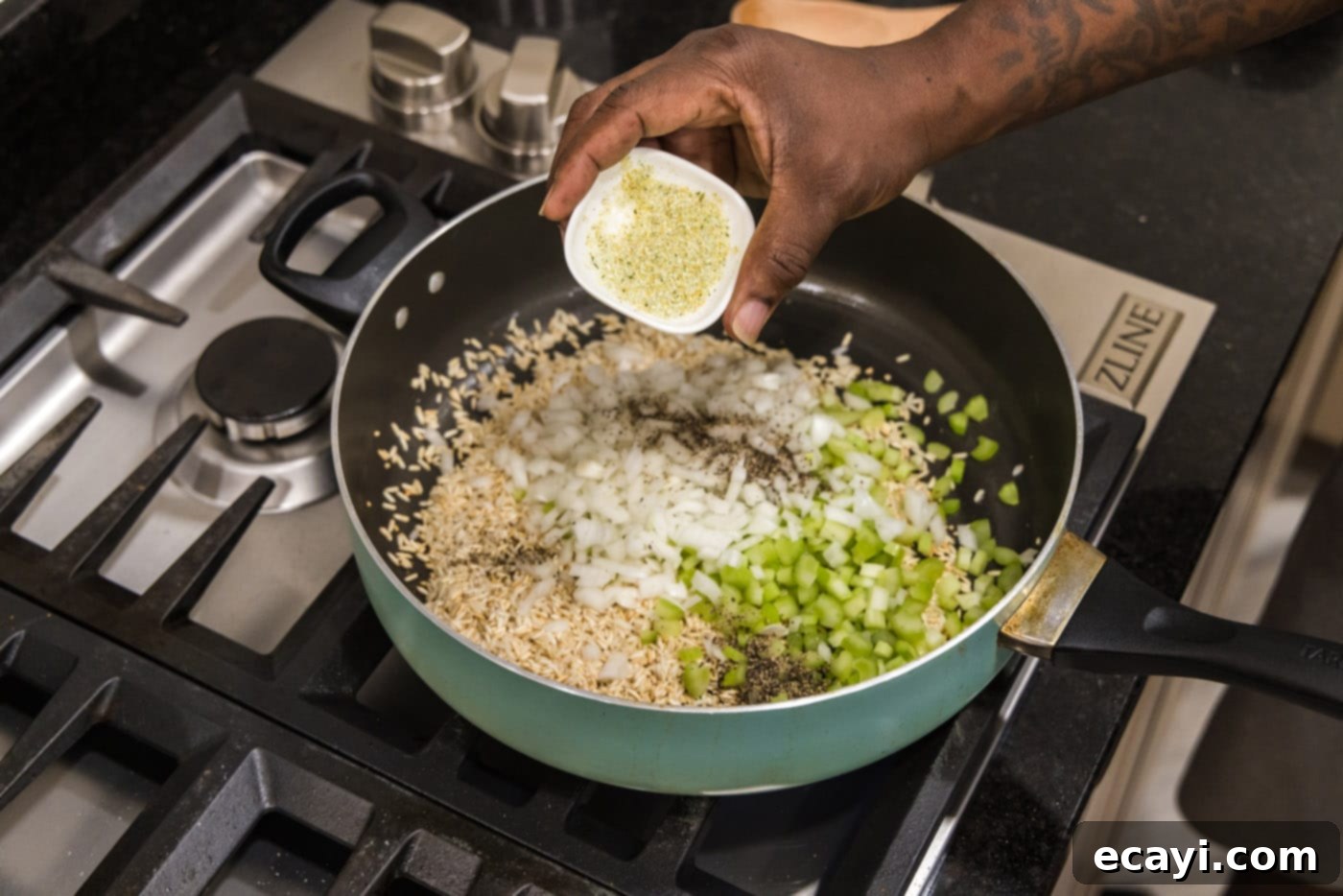 Savory Pilaf Perfection 7 adding garlic salt to celery, onions, rice, and seasonings in a skillet