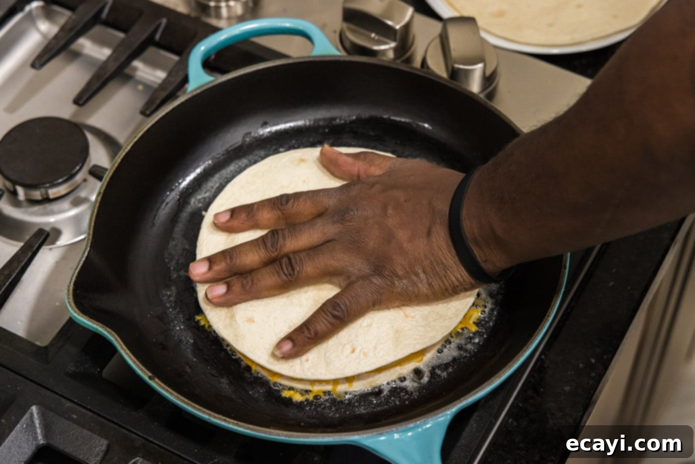Zesty Shrimp Quesadilla 12 Pressing a second tortilla on top of the cheese, shrimp, and vegetable filling in the skillet.