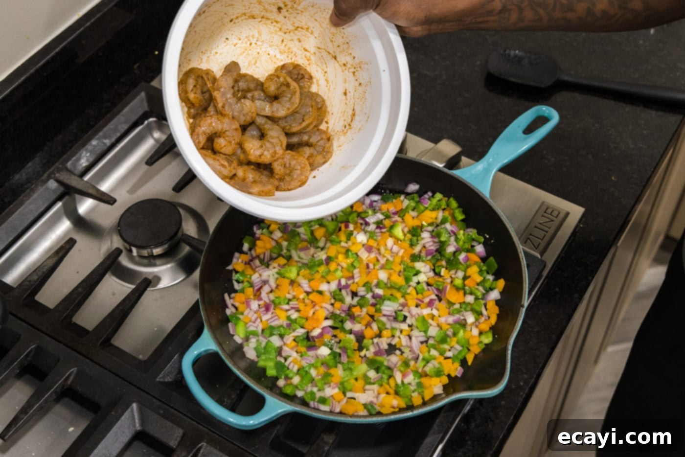 Zesty Shrimp Quesadilla 7 Tossing seasoned shrimp into the skillet with sautéed vegetables, ensuring even cooking.