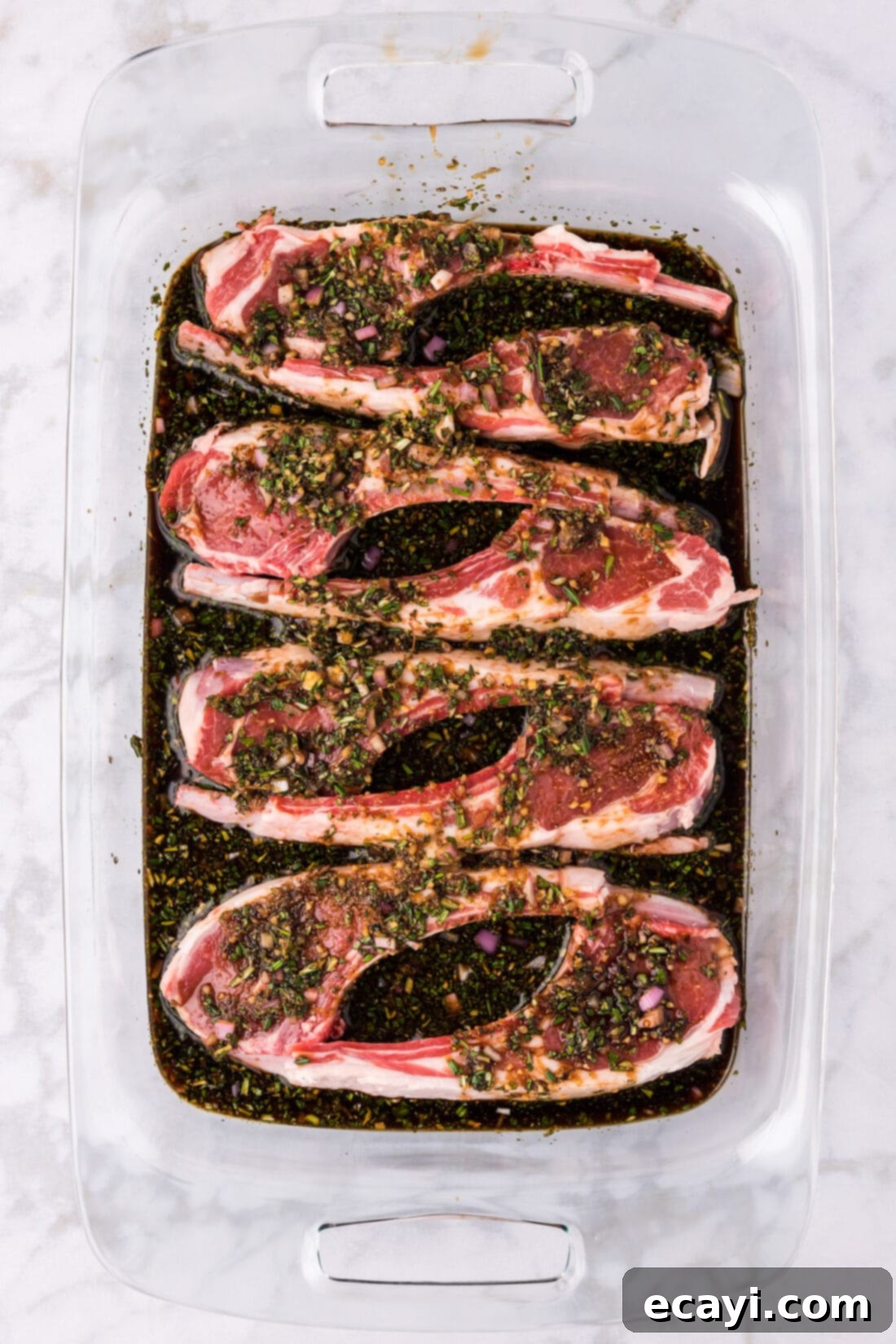 Ultimate Lamb Chop Marinade 2 Lamb Chops and Lamb Chop Marinade sitting in a 13 x 9 pan