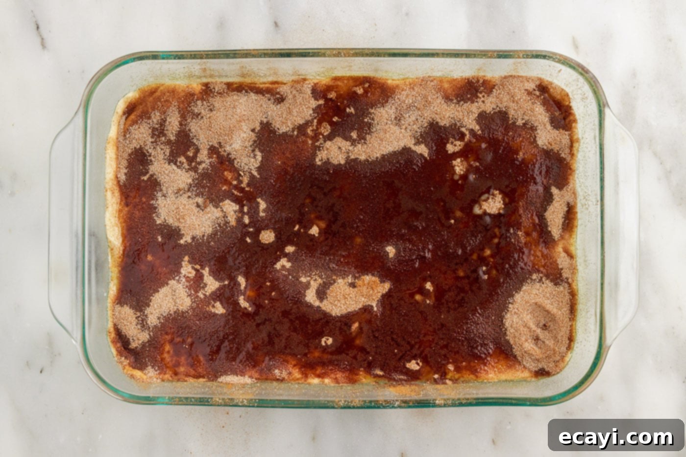 Cinnamon Swirl Sopapilla Cheesecake 15 The Sopapilla Cheesecake bars generously covered with an even layer of cinnamon sugar, ready for baking.