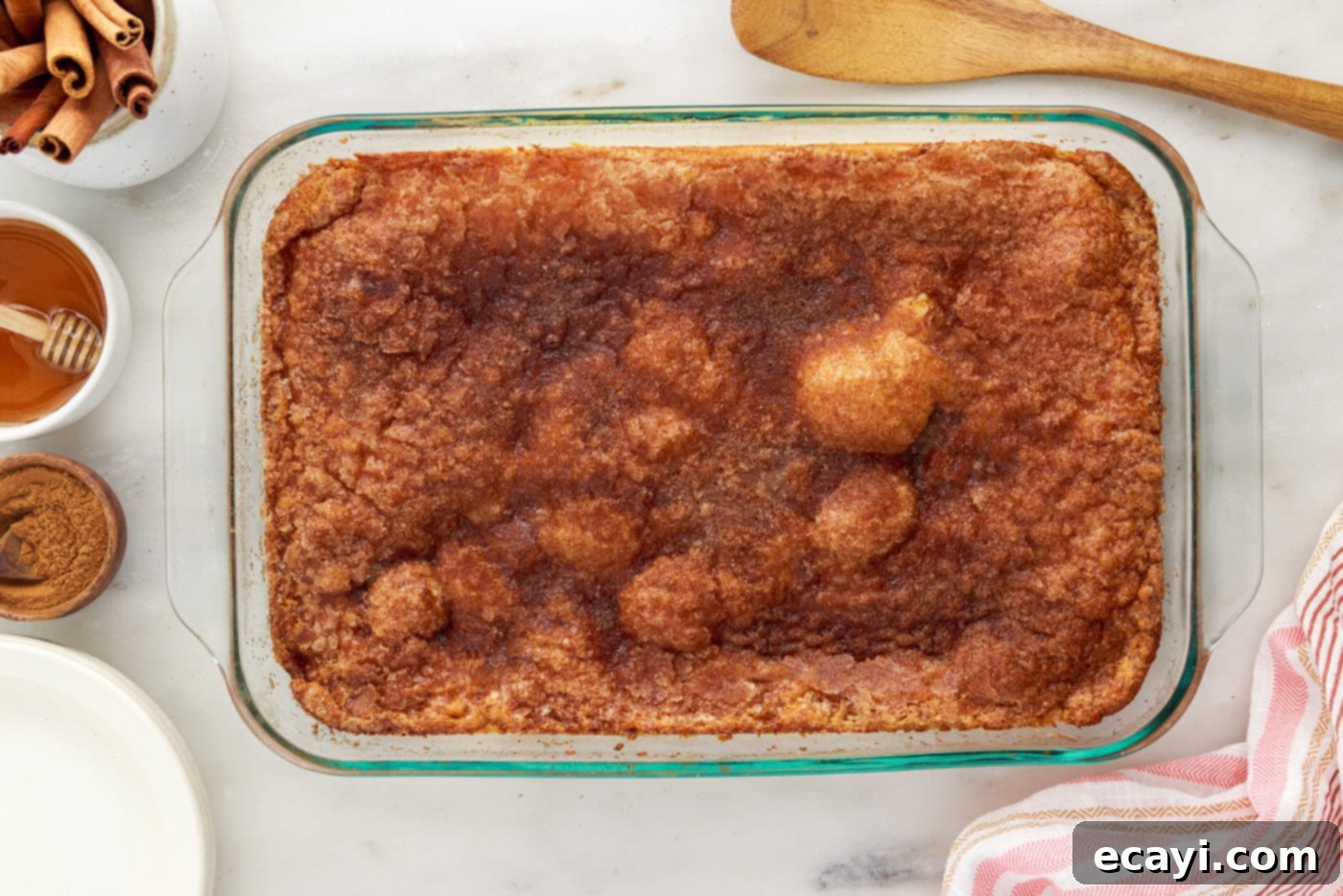 Cinnamon Swirl Sopapilla Cheesecake 16 A pan of freshly baked Sopapilla Cheesecake bars, glistening and golden brown with a puffed top, just removed from the oven.
