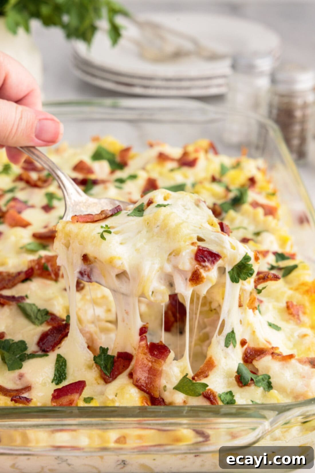 Creamy Chicken Bacon Ranch Bake 2 Spoonful of Chicken Bacon Ranch Casserole being lifted out of the casserole dish of Chicken Bacon Ranch Casserole