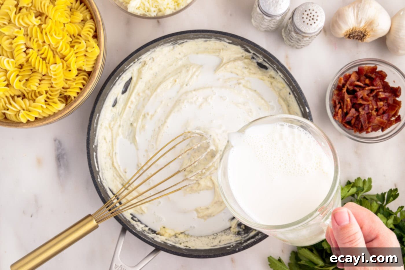 Creamy Chicken Bacon Ranch Bake 8 pouring whole milk into skillet with cream cheese