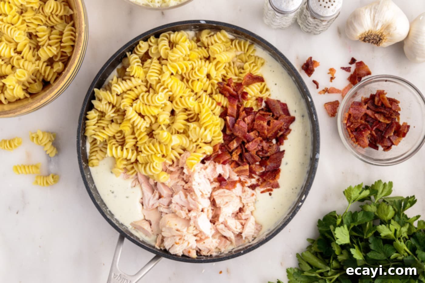 Creamy Chicken Bacon Ranch Bake 10 pasta, bacon, and chicken added to cream cheese sauce in a skillet