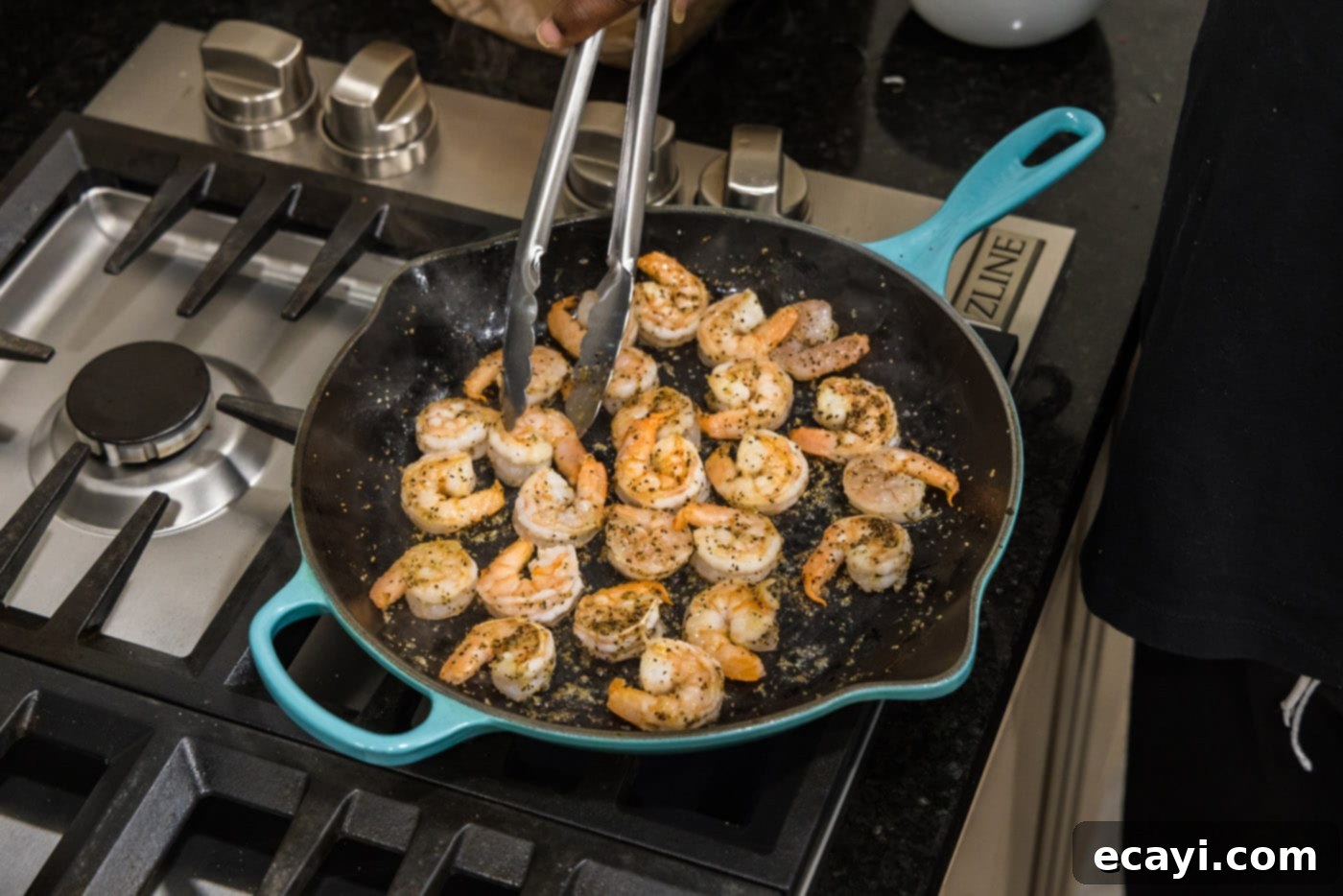 Vibrant Pesto Prawn Pasta 6 turning shrimp in a skillet with tongs