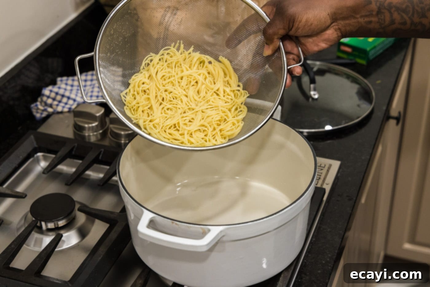 Vibrant Pesto Prawn Pasta 7 draining pasta in a sieve
