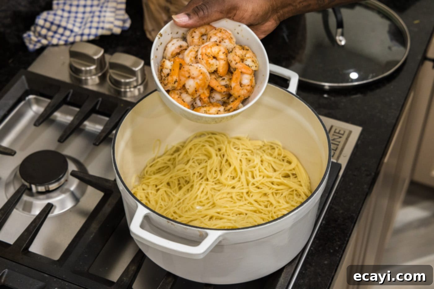 Vibrant Pesto Prawn Pasta 8 adding shrimp to pasta in a pot
