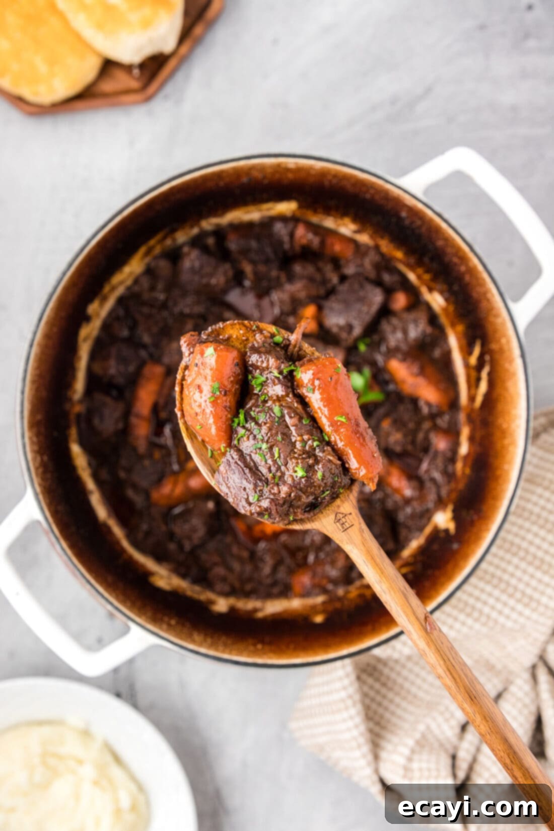 Savory Slow-Braised Beef 3 Spoonful of Braised Beef held over a pot of Braised Beef