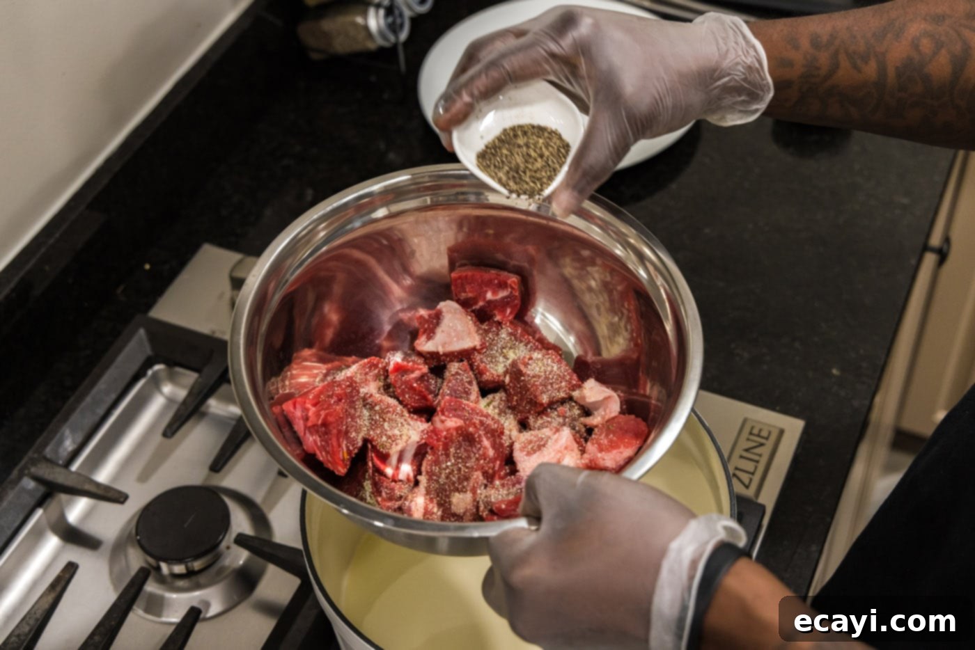 Savory Slow-Braised Beef 6 adding pepper to cubed chuck roast