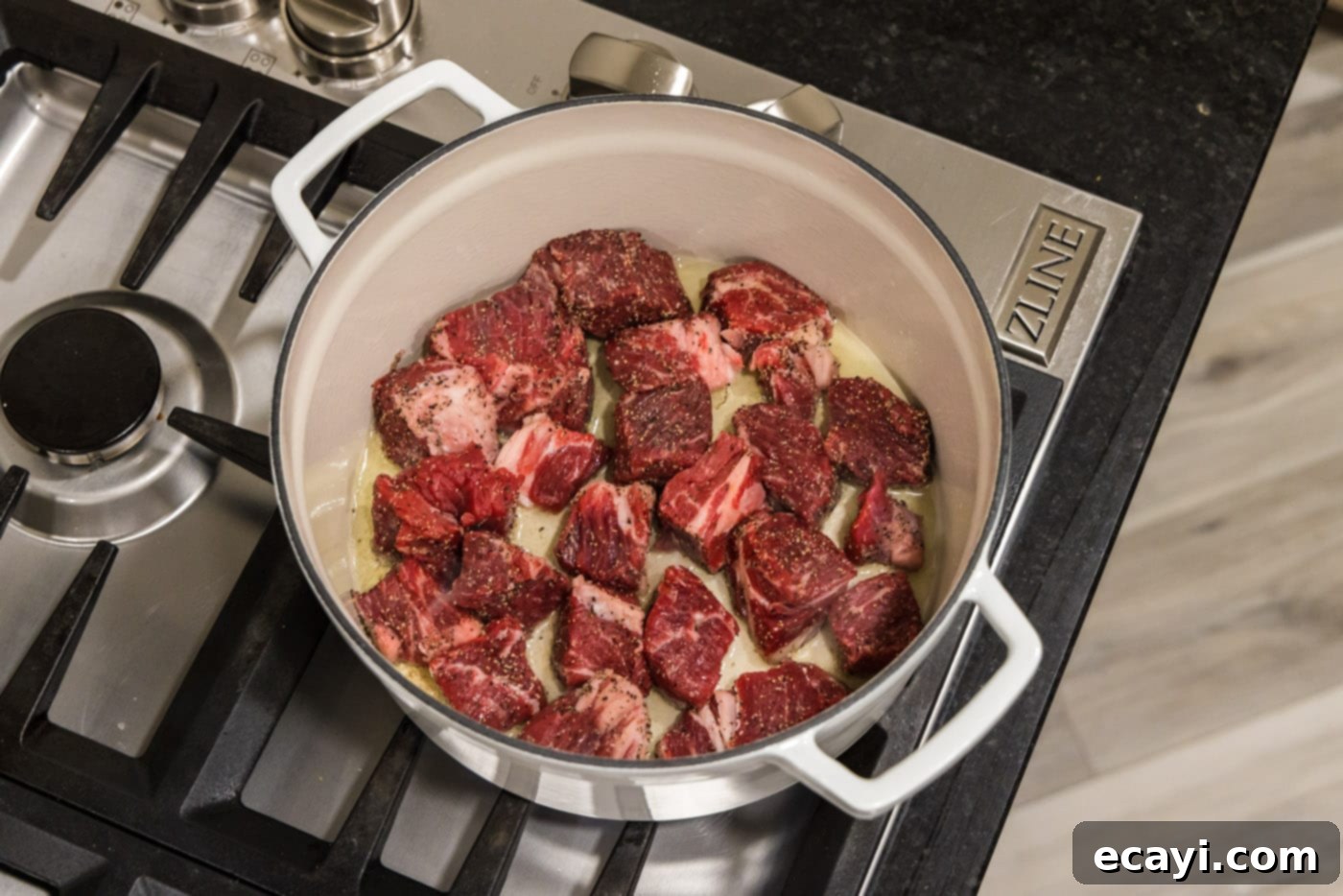 Savory Slow-Braised Beef 7 chuck roast cubes in a dutch oven with oil