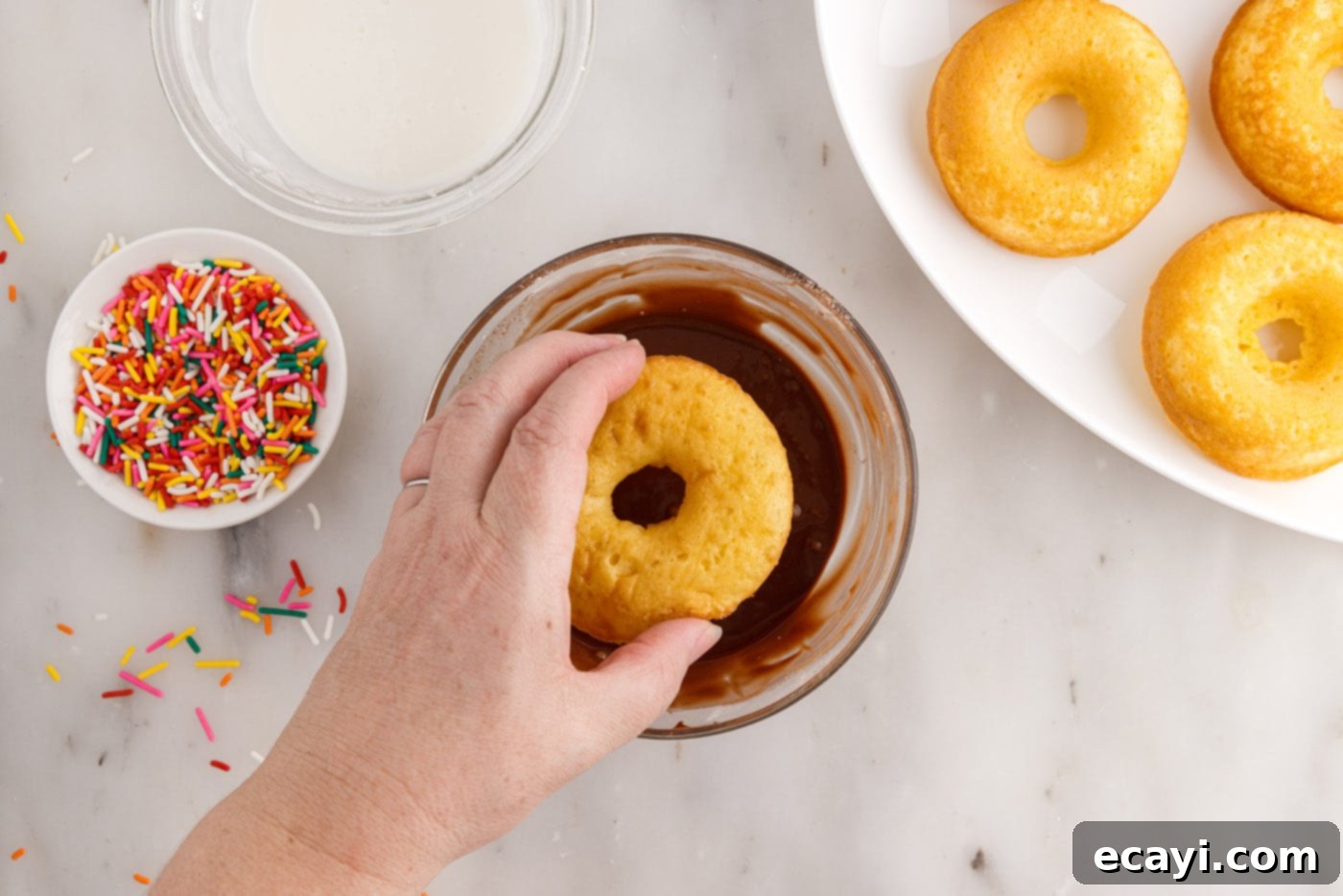 Effortless Cake Mix Donuts 13 dipping donuts in chocolate glaze