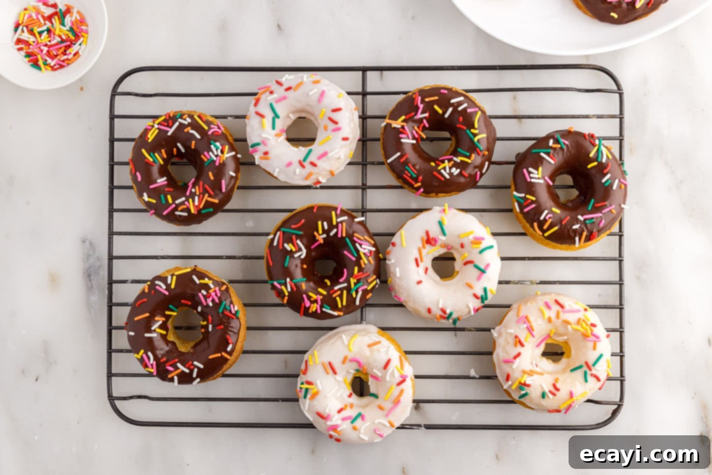 Effortless Cake Mix Donuts 15 cake mix donuts with vanilla and chocolate glaze topped with sprinkles