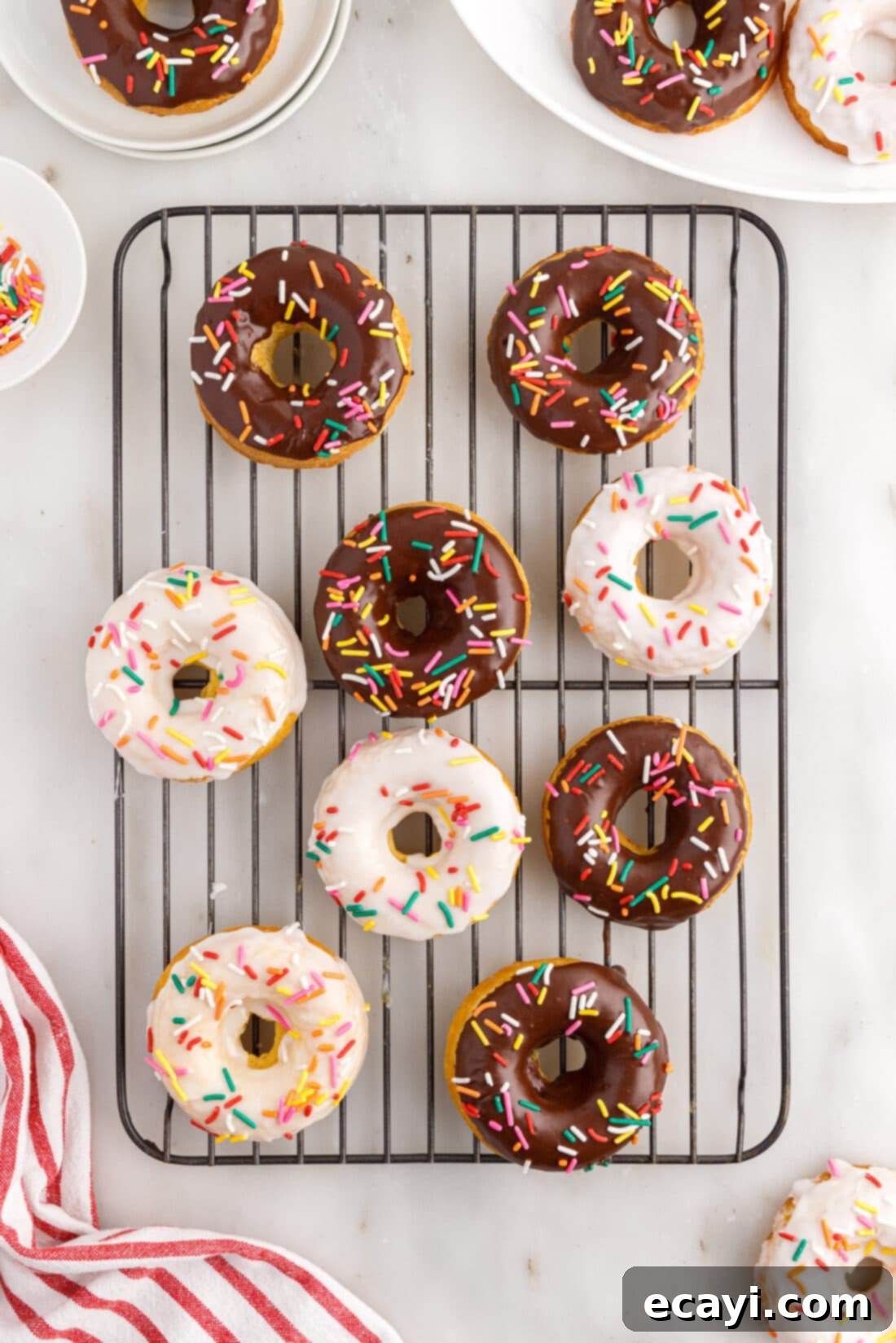 Effortless Cake Mix Donuts 3 Cake Mix Donuts resting on a wire cooling rack